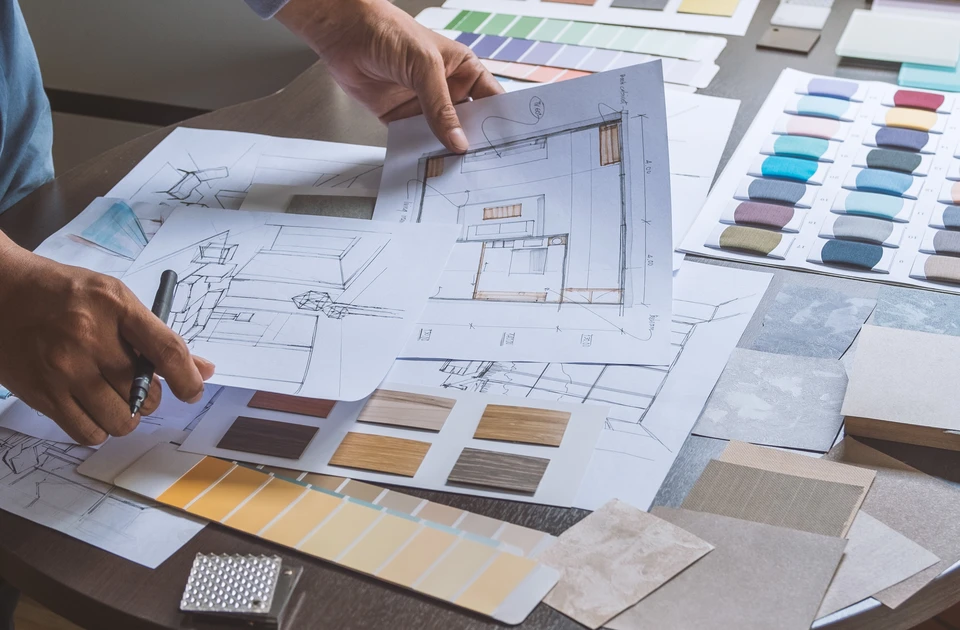 Sc&egrave;ne d'int&eacute;rieur avec deux personnes consultant des plans d'architecture sur parquet bois
